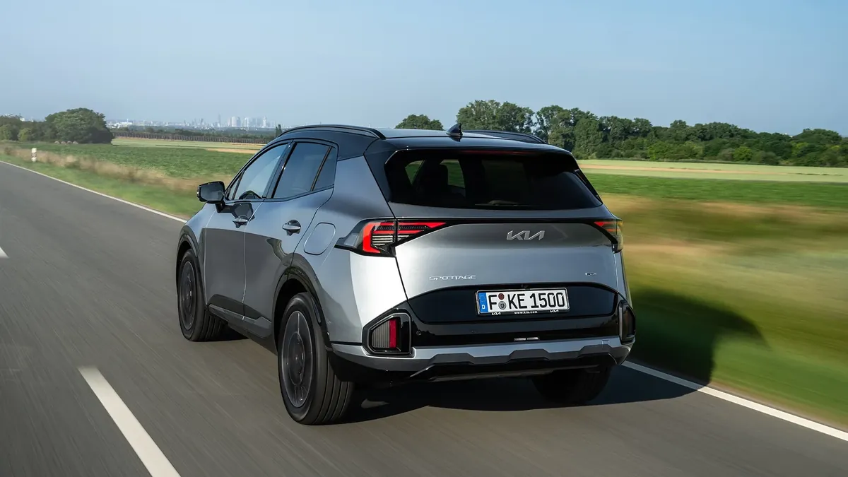 2026 Kia Sportage rear view on a country road