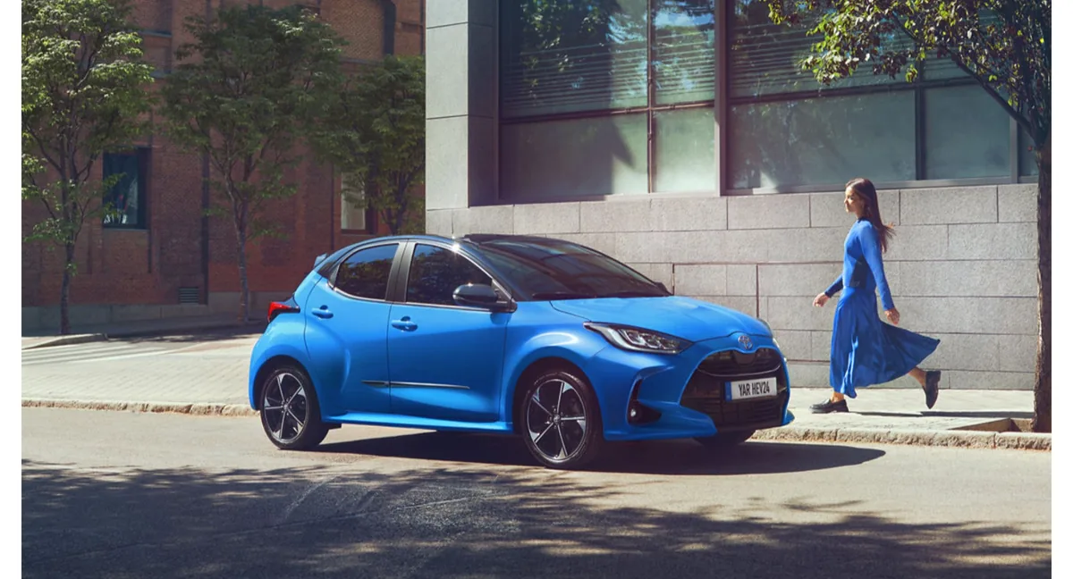 Blue Toyota Yaris Hybrid on a street